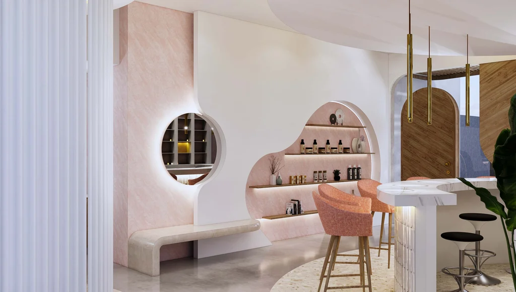 Modern, aesthetic interior of Moiselle salon, a luxury beauty parlour Canggu, featuring curved pink and white walls, illuminated arched shelving, and a stunning marble studio.