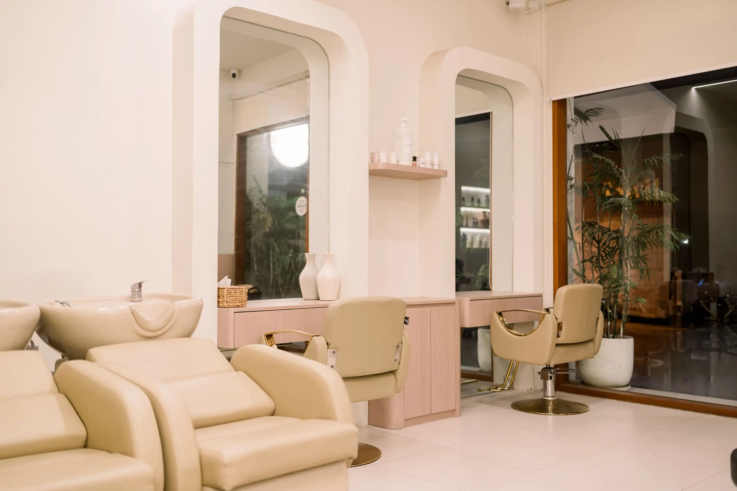Salon Bali destination: the best beauty studio in Canggu Bali and nail salon at Moiselle one stop beauty Canggu salon, featuring beige reclining chairs, soft lighting, and modern arched mirrors.